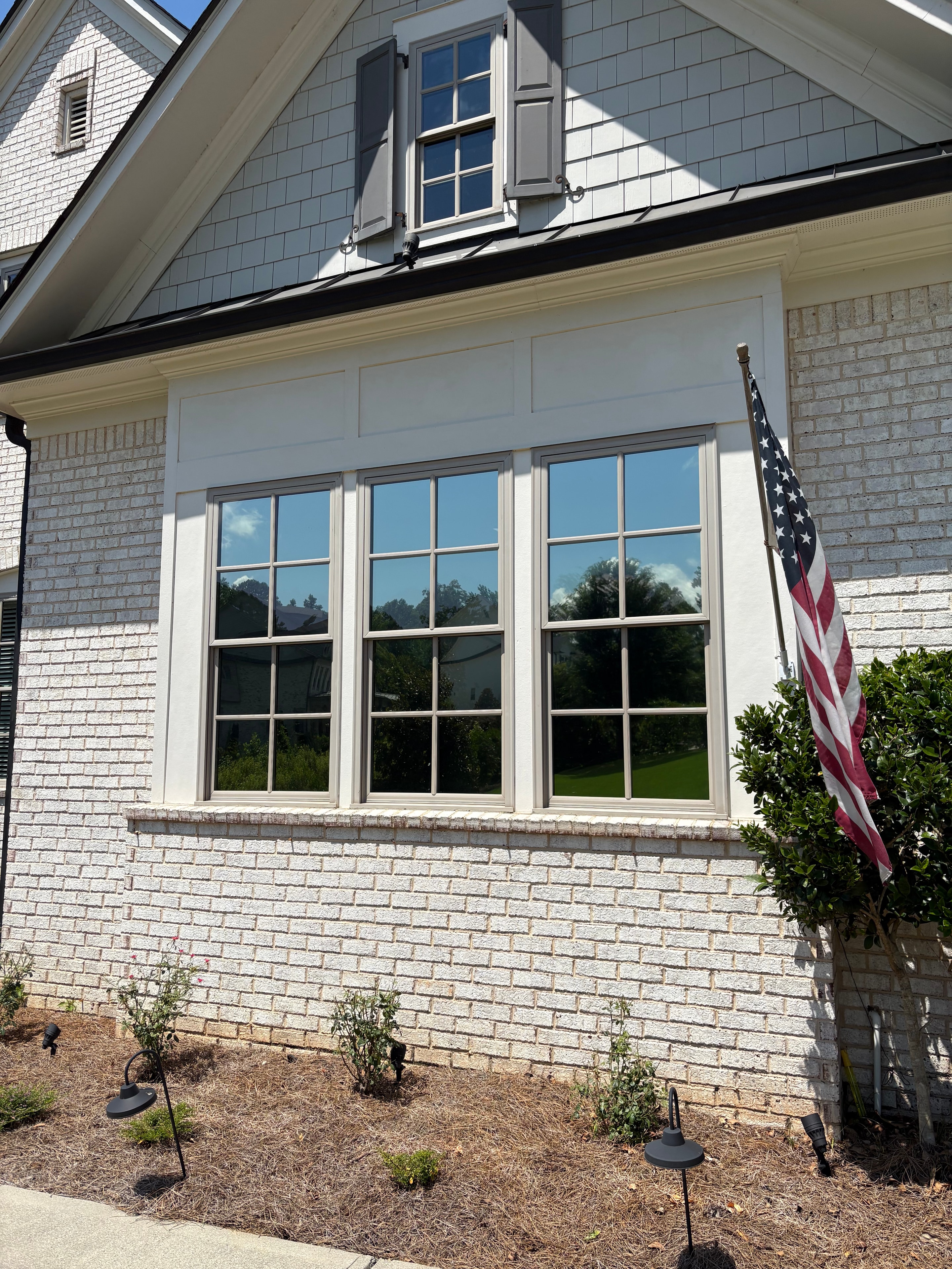 White Columns subdivision garage windows in Milton GA with Madico Optivision 5 privacy film installed by Sungate