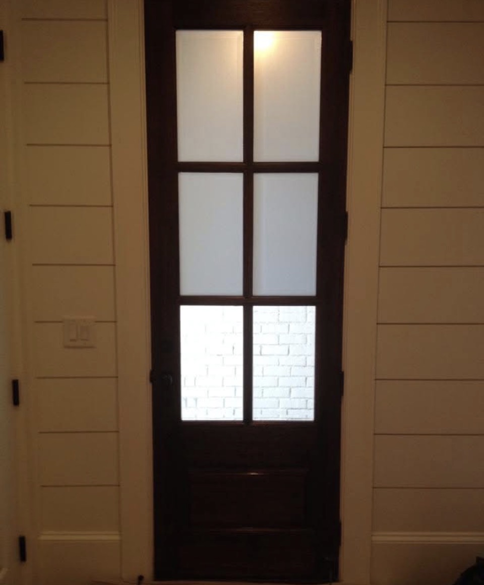 French door with frosted film on upper panels, clear view through lower panels