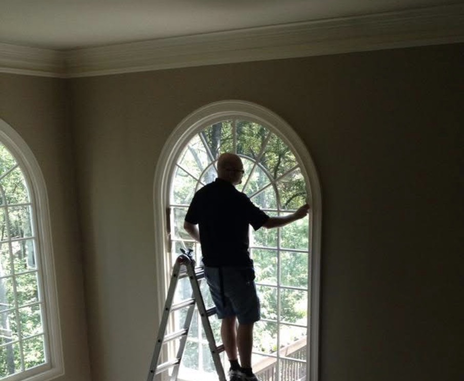 Oval window with frosted privacy film and decorative grid pattern