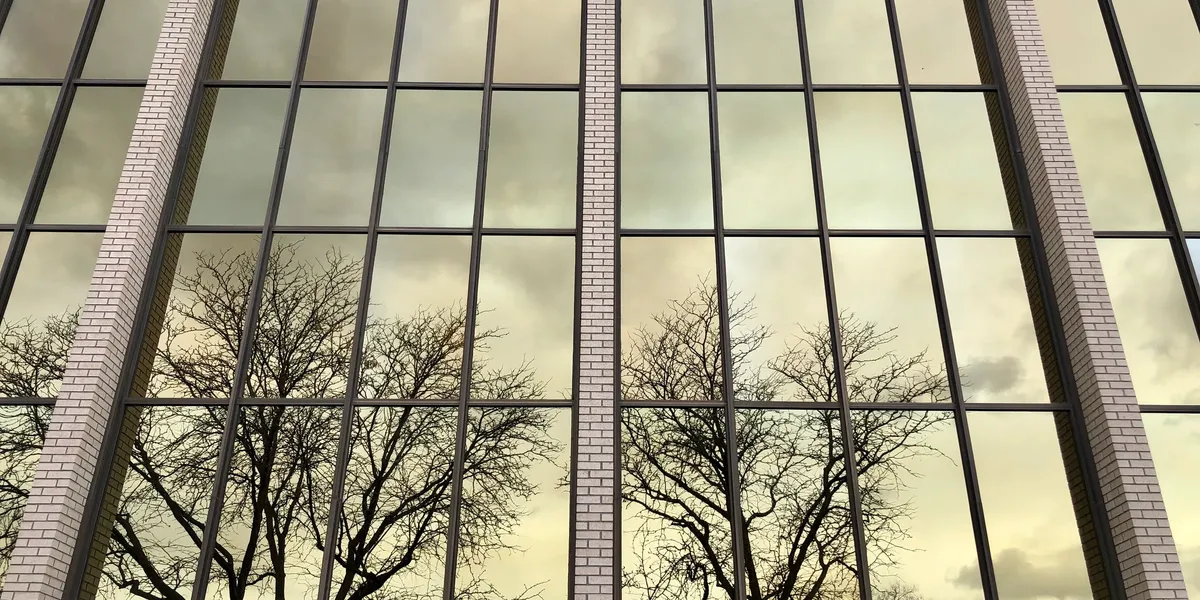 Modern white home exterior with tinted windows