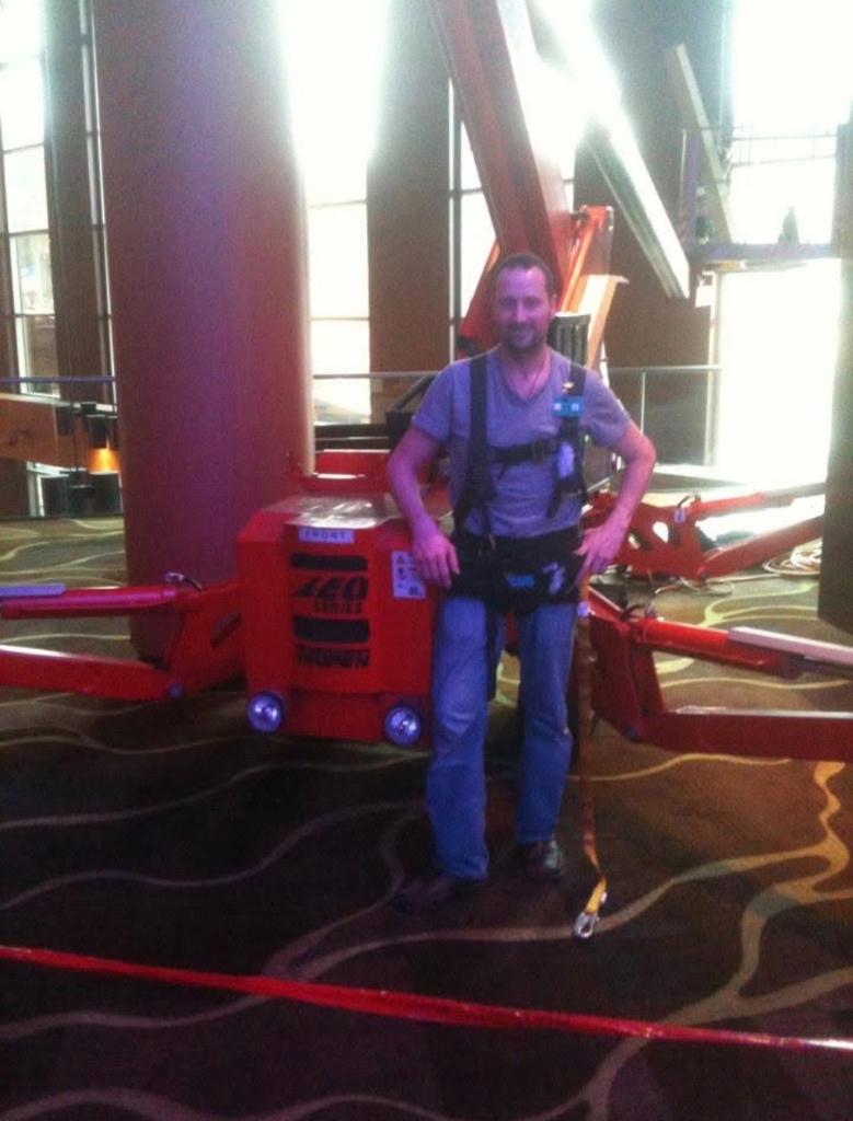 Joe from Sungate with spider lift for high-rise commercial window tinting