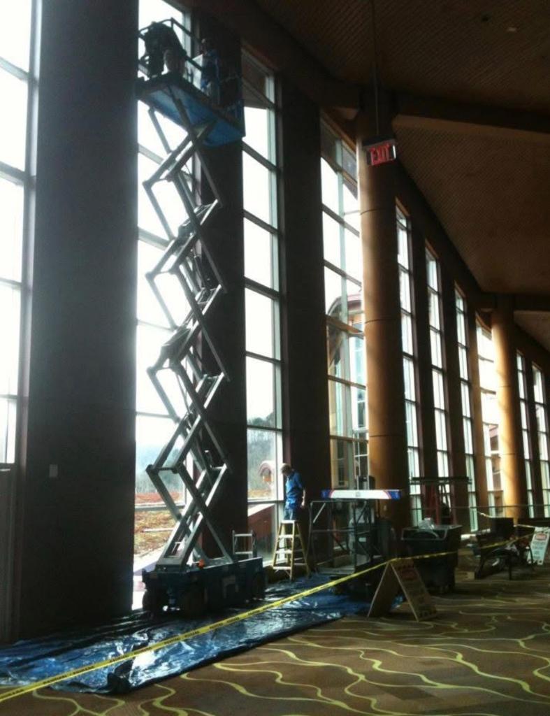 Scissor lift on tall commercial windows during installation