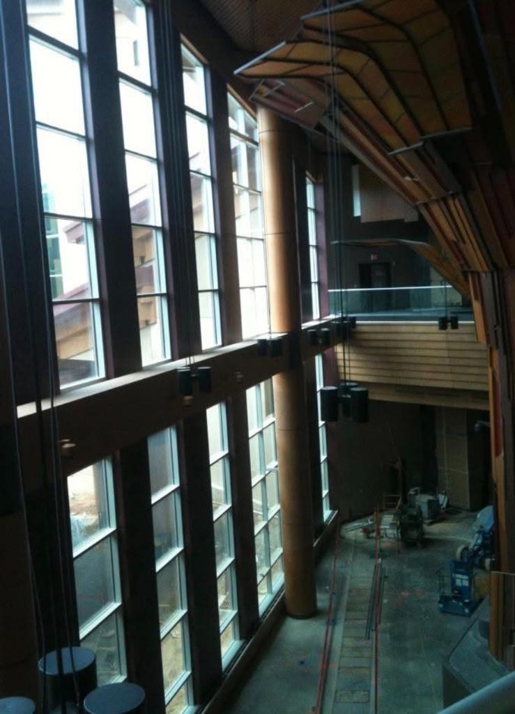 Large commercial atrium interior with arched ceiling and tall windows