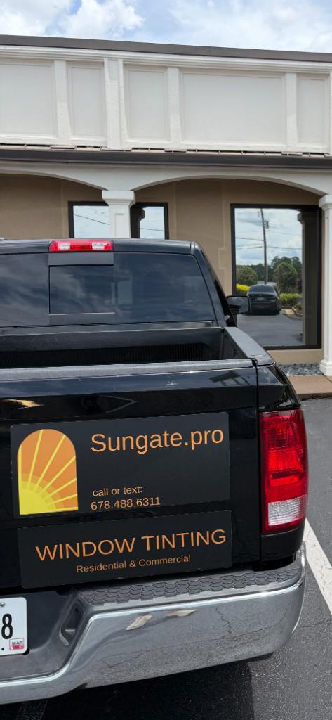 Sungate window tinting truck with branding parked outside commercial building