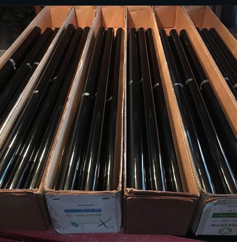 Boxes of Hüper Optik window film rolls ready for installation