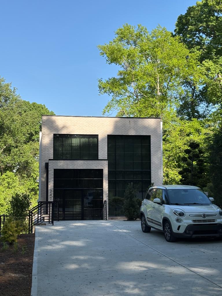 Modern commercial building exterior with large tinted black-frame windows