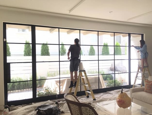 Sungate team installing window film on large glass wall