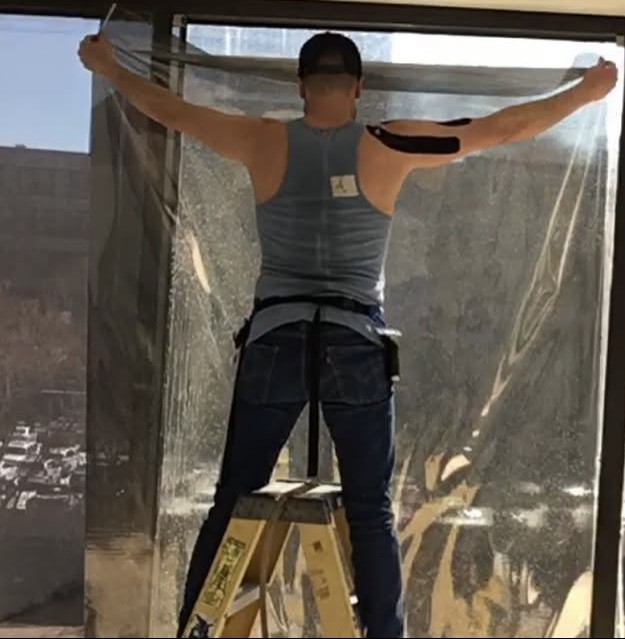 Sungate technician applying window film