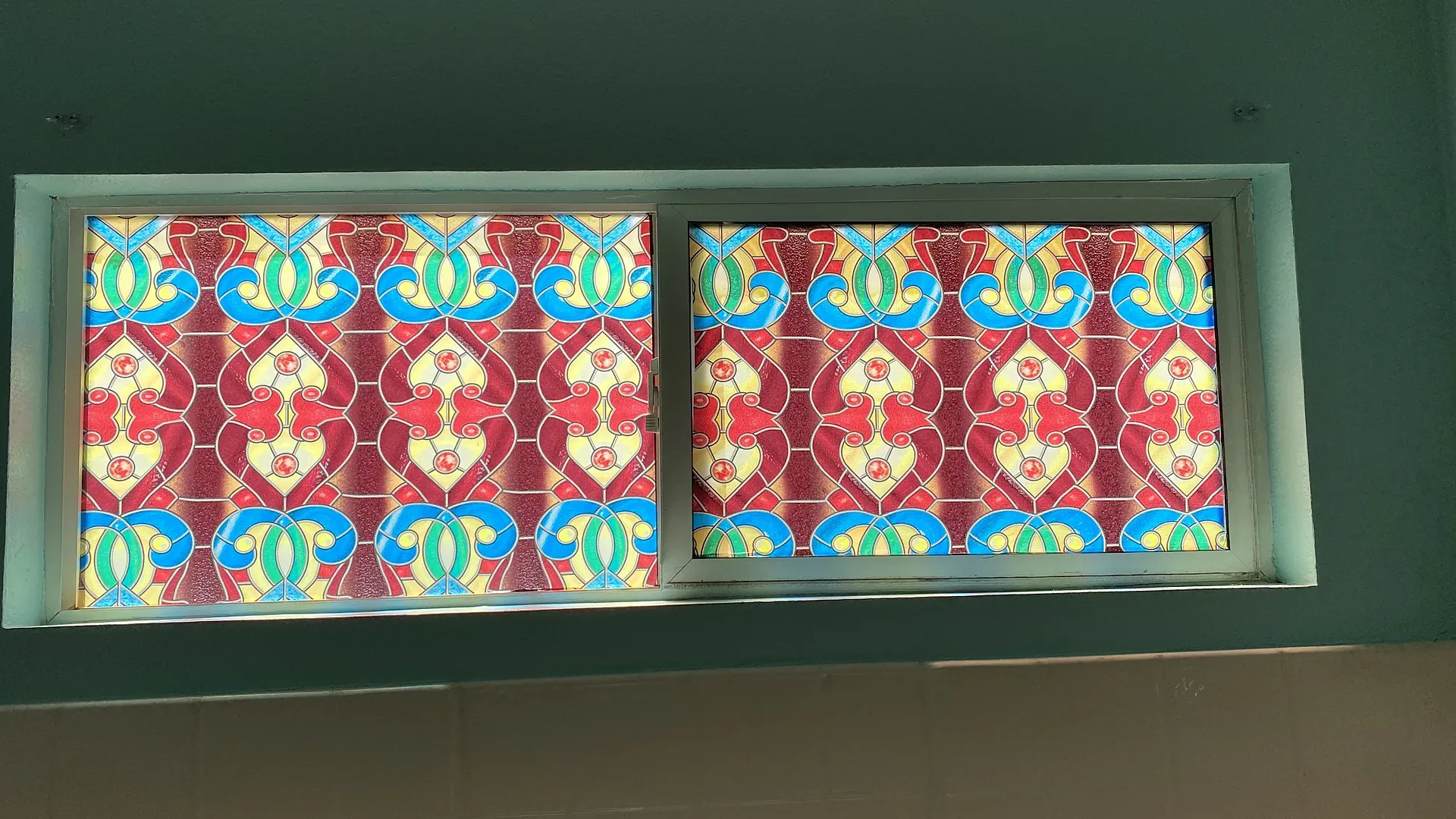 Transom windows with sxeg-1028 vibrant red and blue stained glass medallion pattern film