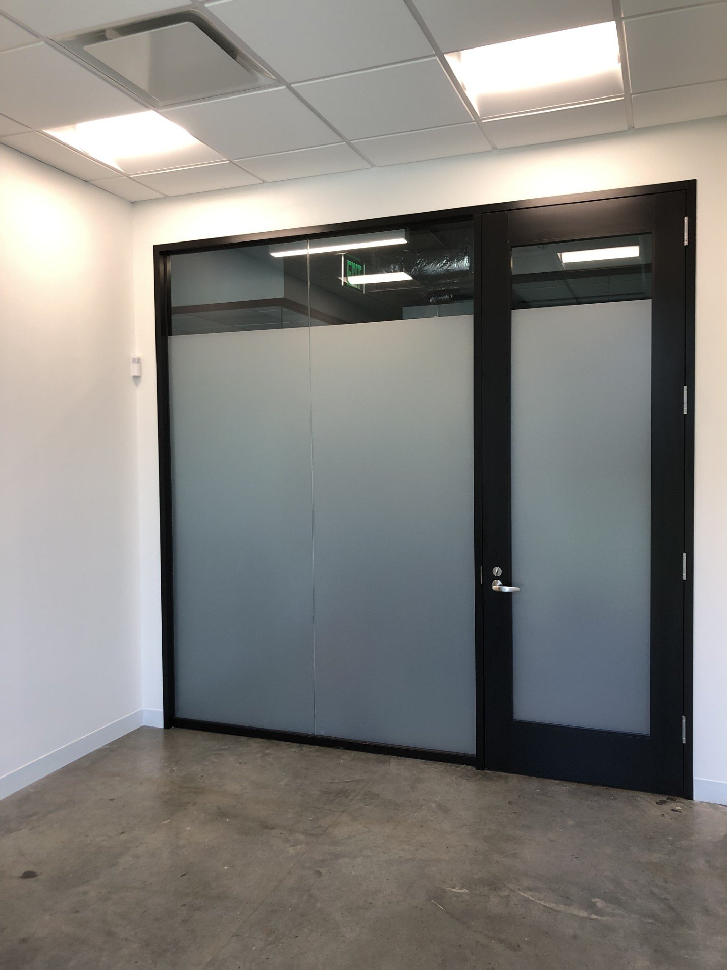 Large commercial curtain wall window film installation in progress